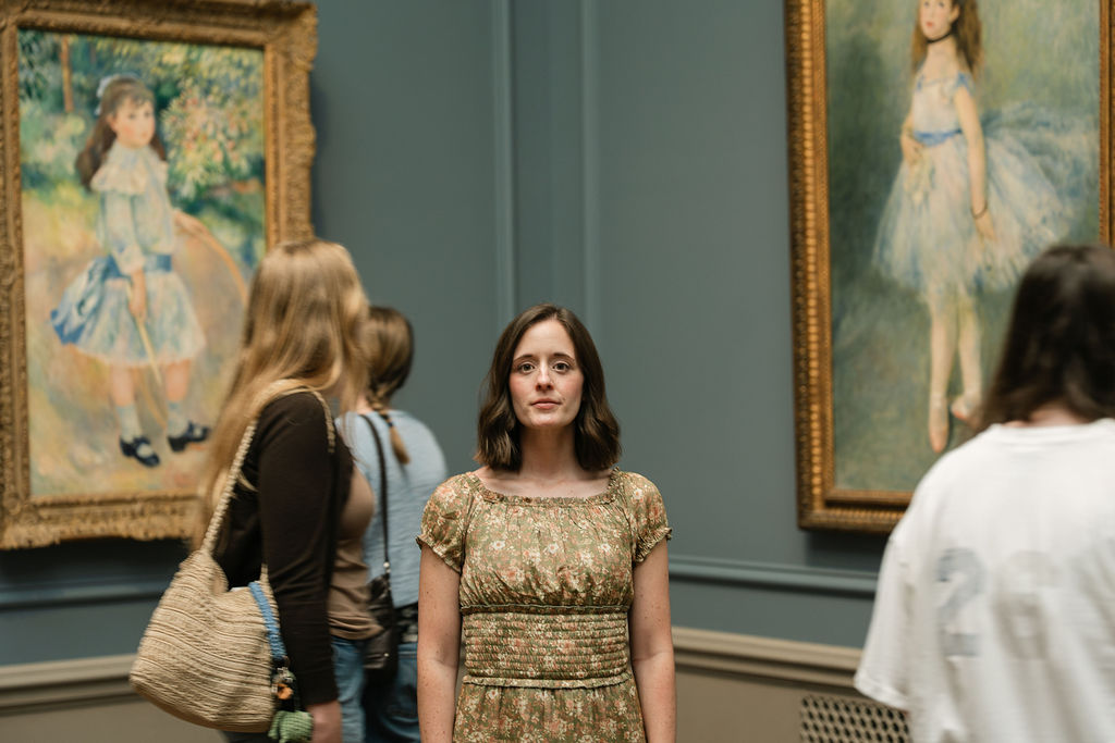 Violinist Emily standing in a gallery at the National Gallery of Art in Washington, DC