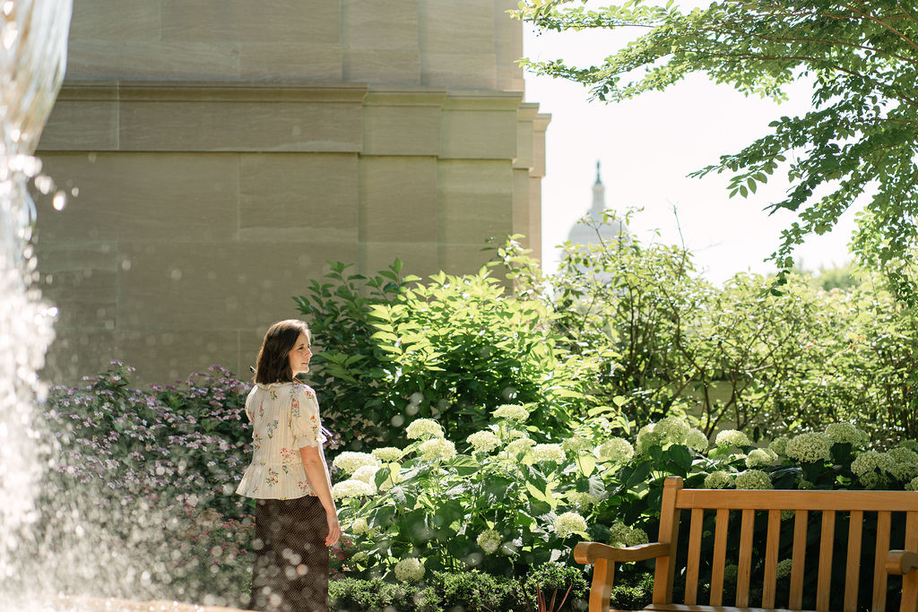 Emily surrounded by flowers outside the National Gallery of Art