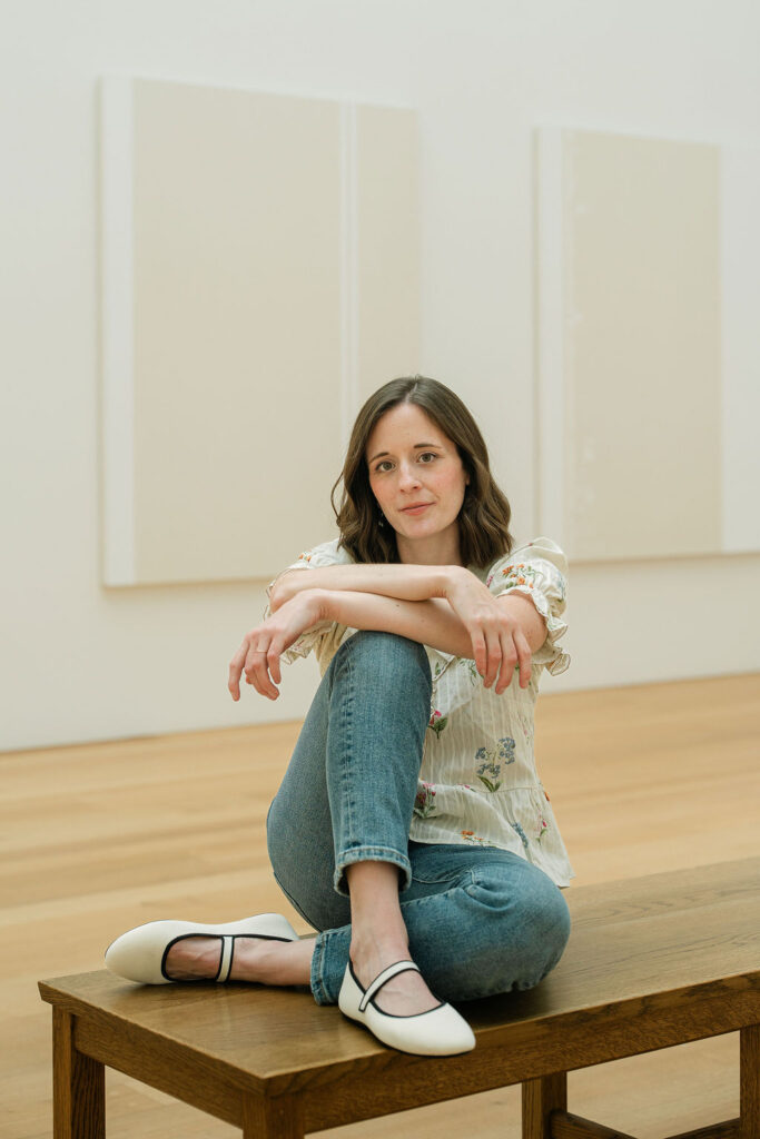 Musician portrait featuring Emily on a bench inside an art museum in Washington, DC