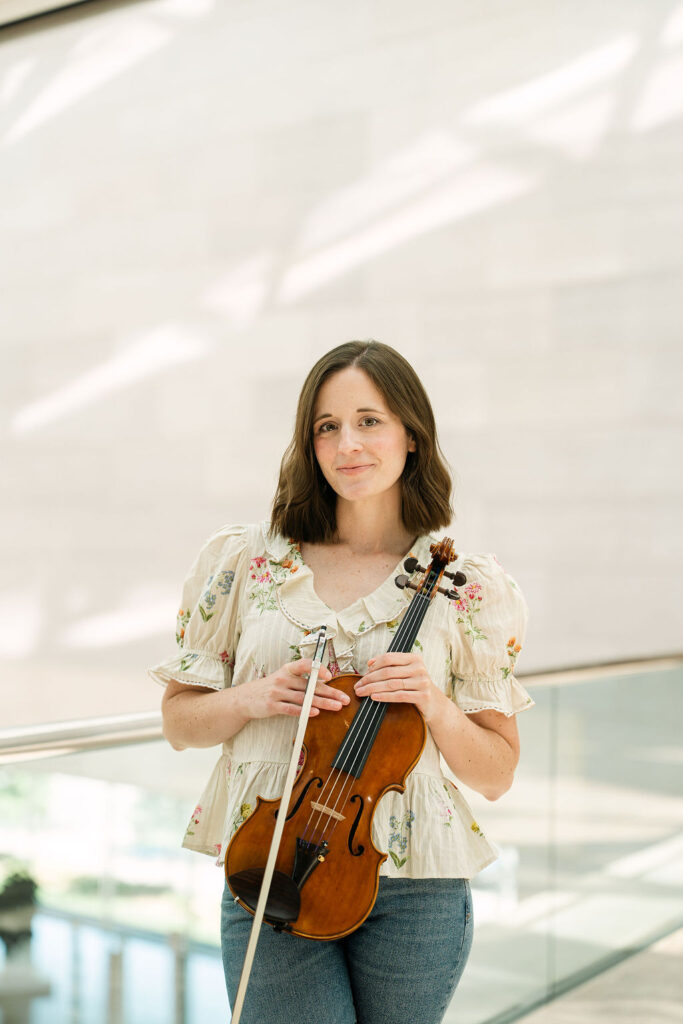 Emily posing with her violin at the National Gallery of Art