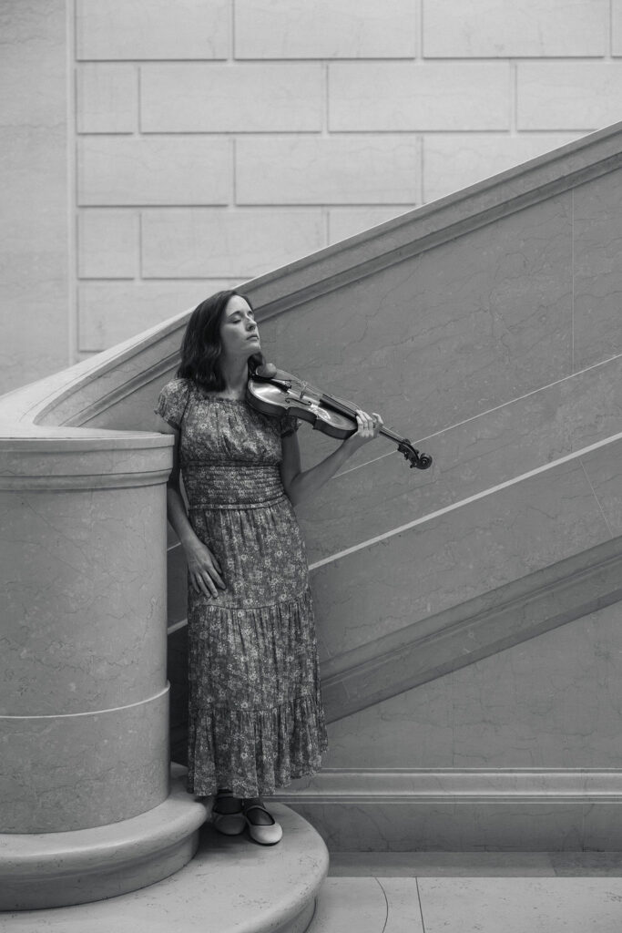 Musician portrait featuring Emily and her violin inside an art museum in Washington, DC