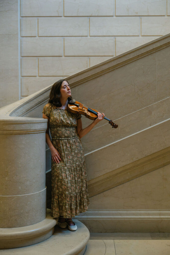 Portrait of a violinist with her instrument in an art gallery in Washington, DC