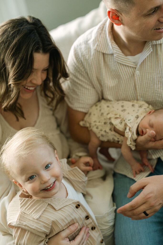 Family of four cuddling together during a newborn session