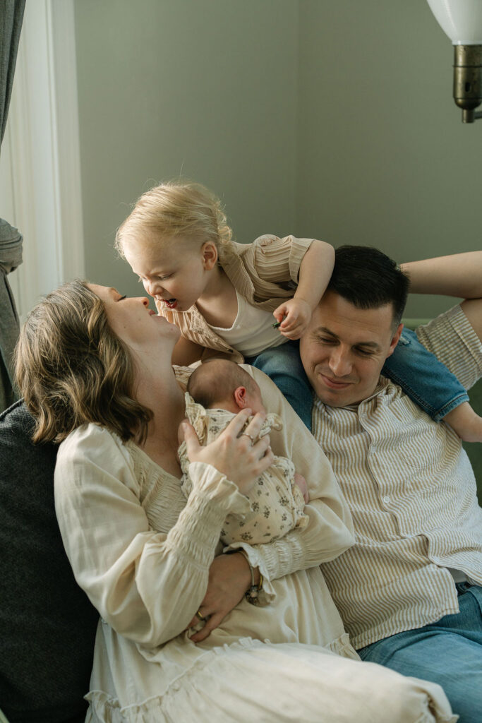 Family of four cuddling together during a newborn session