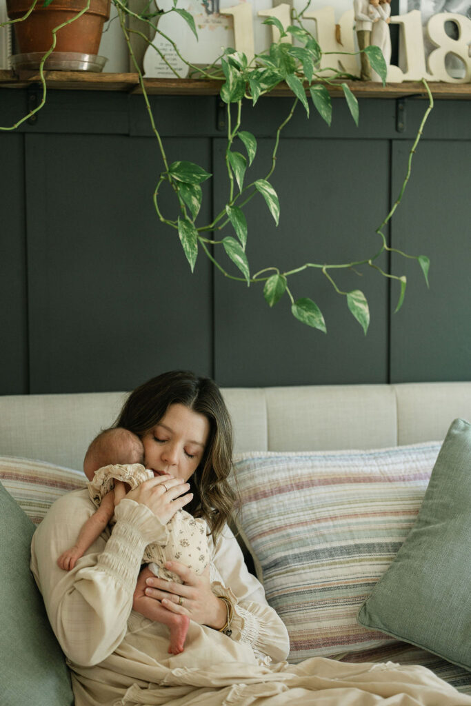 Mother cuddling her newborn daughter at home