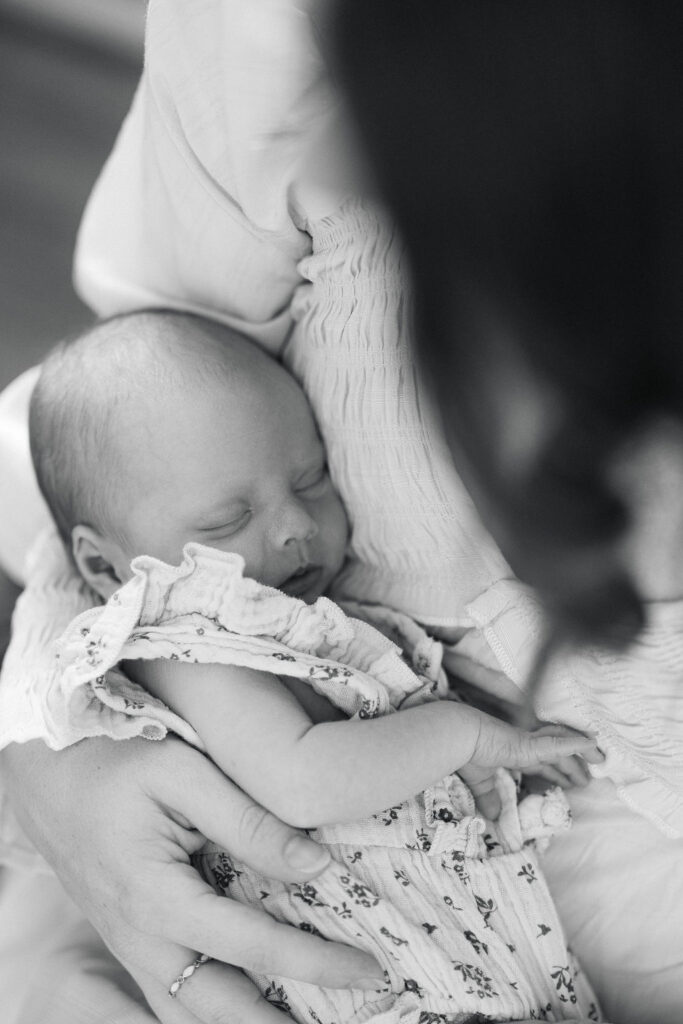 Black and white portrait of a mother holding her newborn baby