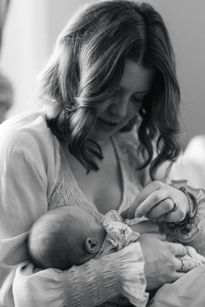 Black and white portrait of a mother holding her newborn baby